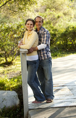 Caucasian couple on outdoor wooden bridge