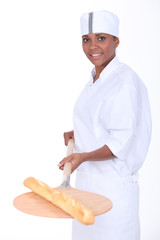 Young woman baker on white background