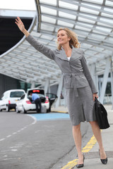 Businesswoman stopping taxi