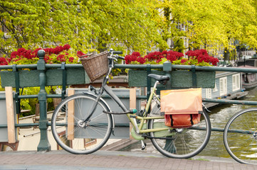 Naklejka premium Bike parked on a bridge in Amsterdam, Netherlands