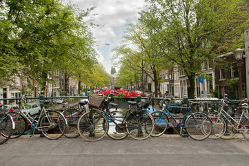Fototapeta premium Bikes parked on a bridge in Amsterdam, Netherlands