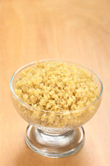 Cooked white quinoa in glass bowl