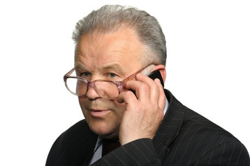The elderly man talks by a mobile phone