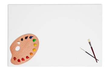 Blank canvas brushes and paint palette isolated on white