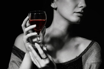 Glass with a red wine in a female hand
