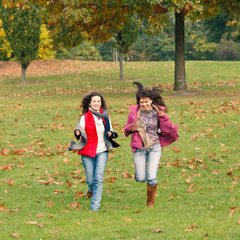 Two pretty girls having fun in a park