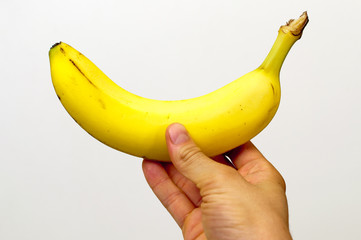 Right hand holding a yellow banana