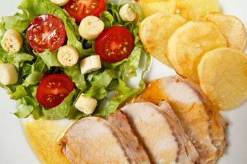 Roasted pork with potatoes and fresh salad