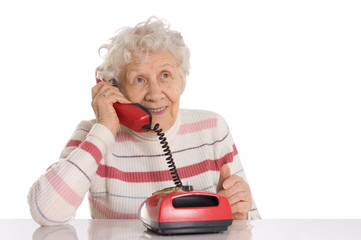 The elderly woman speaks on phone