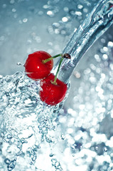 blurry water being poured on cherries