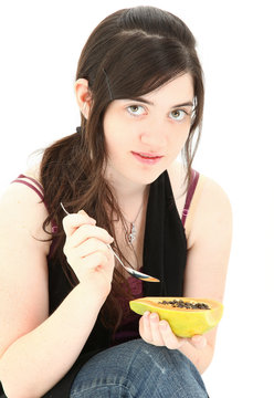 Attractive Young Woman Eating Papaya Fruit