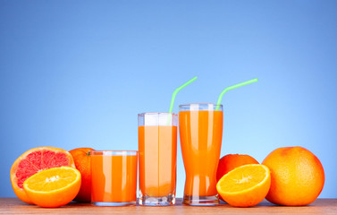 Juice and  oranges on blue background