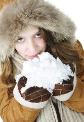 Playful winter girl holding snow