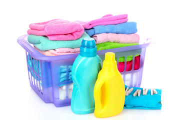 Detergents and towels in basket isolated on white