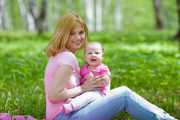Naklejka na ściany i meble Mother and daughter in birch spring park