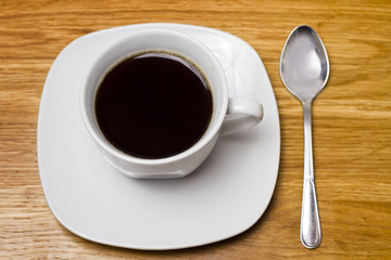 black coffee cup on wooden table
