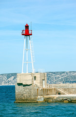 Fototapeta na wymiar Light beacon at the entrance of a harbor