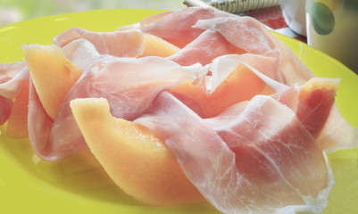 Italian ham with slices of a net melon