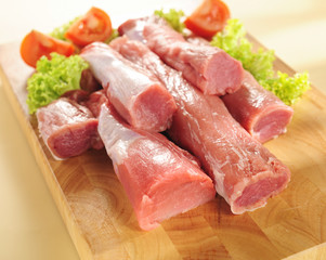 Pork tenderloin. Arrangement on a cutting board.