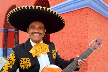 Charro Mariachi playing guitar Mexico houses
