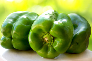 Green peppers on table.