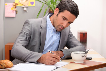 Businessman working at his breakfast bar