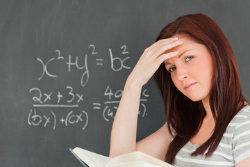 Thoughtful woman trying to solve an equation