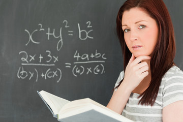 Reflective young woman trying to solve an equation