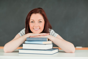Young student with the chin on her books