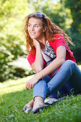 Woman sitting on grass in park