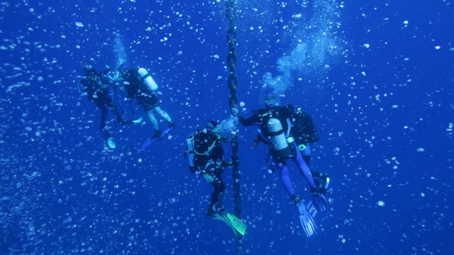 Divers on 5 min stop after Zenobia dive, with hundreds bubbles