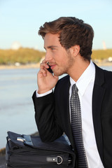 Young man talking on phone outdoors