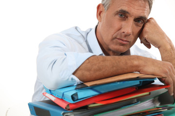 Man leaning on stack of work