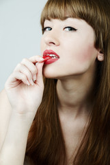 sexy woman putting a jelly candy into her mouth