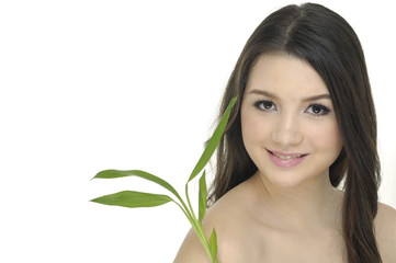Naklejka premium girl holding green bamboo in her hands