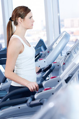 Young woman at the run at gym