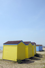 Fototapeta na wymiar Beach huts by the sea at Littlehampton in Sussex