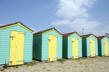 Fototapeta na wymiar Beach huts by the sea at Littlehampton in Sussex
