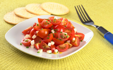 Cherry tomato wedges with cheese and chives
