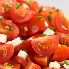 Cherry tomato wedges with cheese and chives