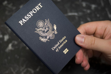 Hand holding American passport