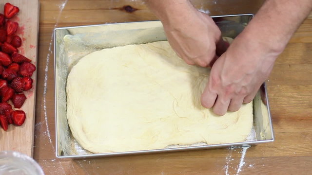 Putting dough into roasting pan, time lapse, top view