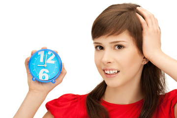 teenage girl holding alarm clock