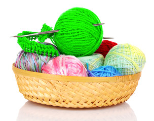 Balls of color knitting wool or yarn in basket on white