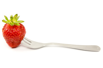 strawberry on a fork isolated over white background.