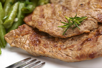 Beef meat slices with beans and rosemary