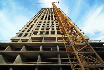 Tall building under construction with crane