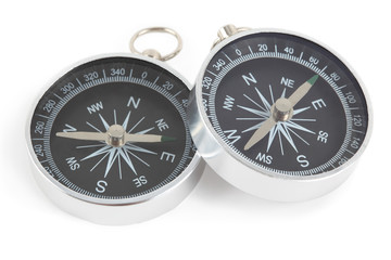 Two silver compasses with black panel isolated on white