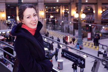 smiling woman close up stands half-turned on second floor