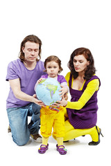 Father, mother and daughter hold inflatable ball-earth.